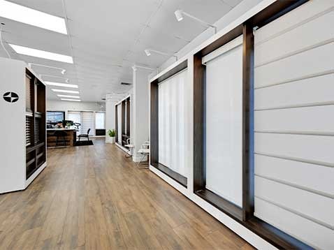 Store interior showcasing several different types of window coverings
